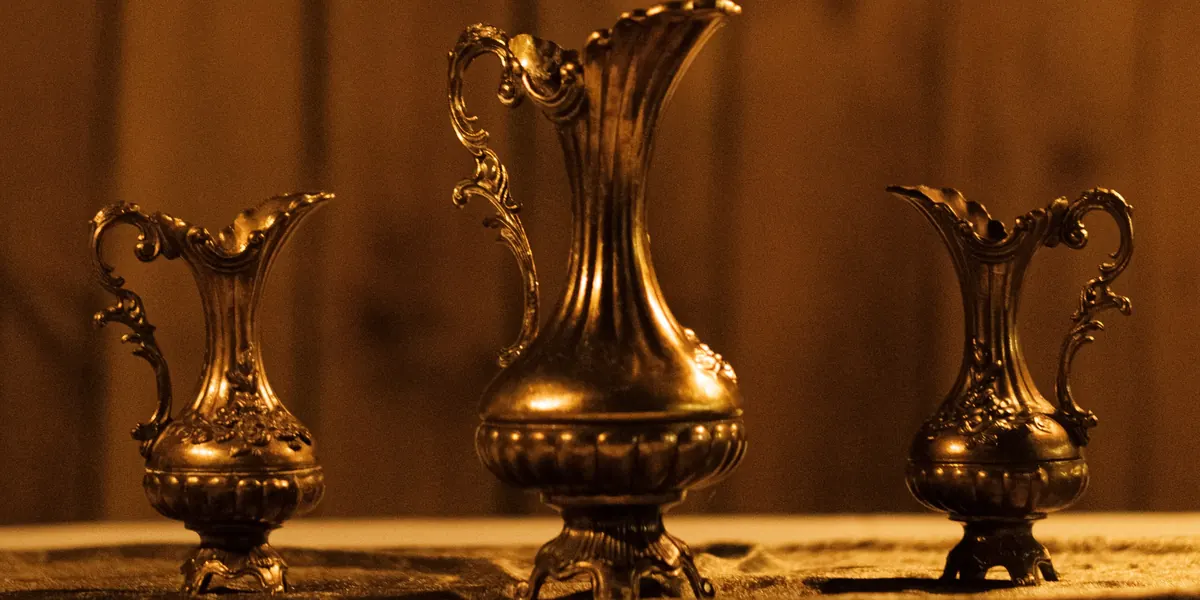 Three ornate Italian brass vases, one large between two small